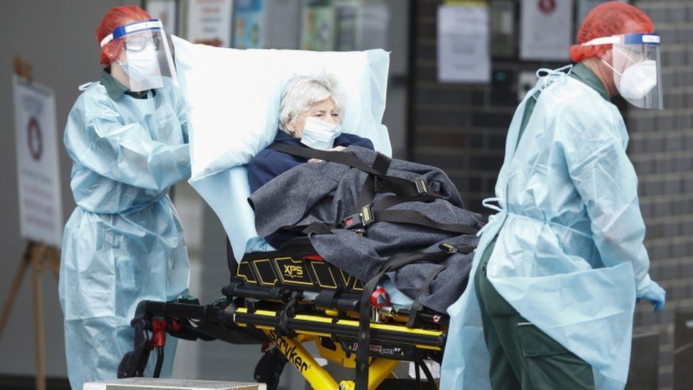 A resident of the Epping Gardens Aged Care Facility is taken away in an ambulance in Epping, outskirts of Melbourne, Australia