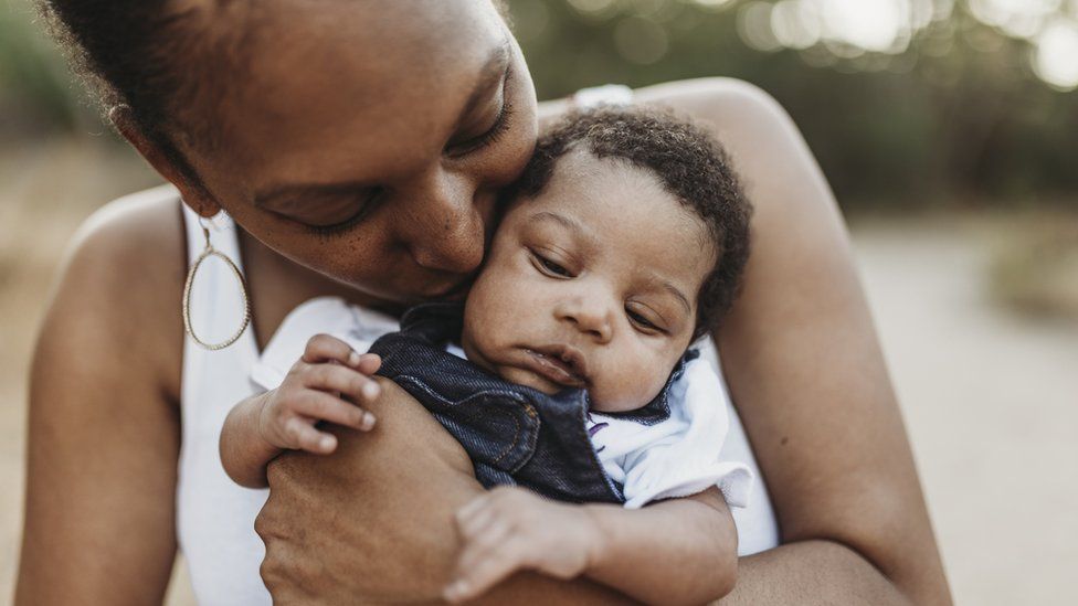 A woman holding a baby