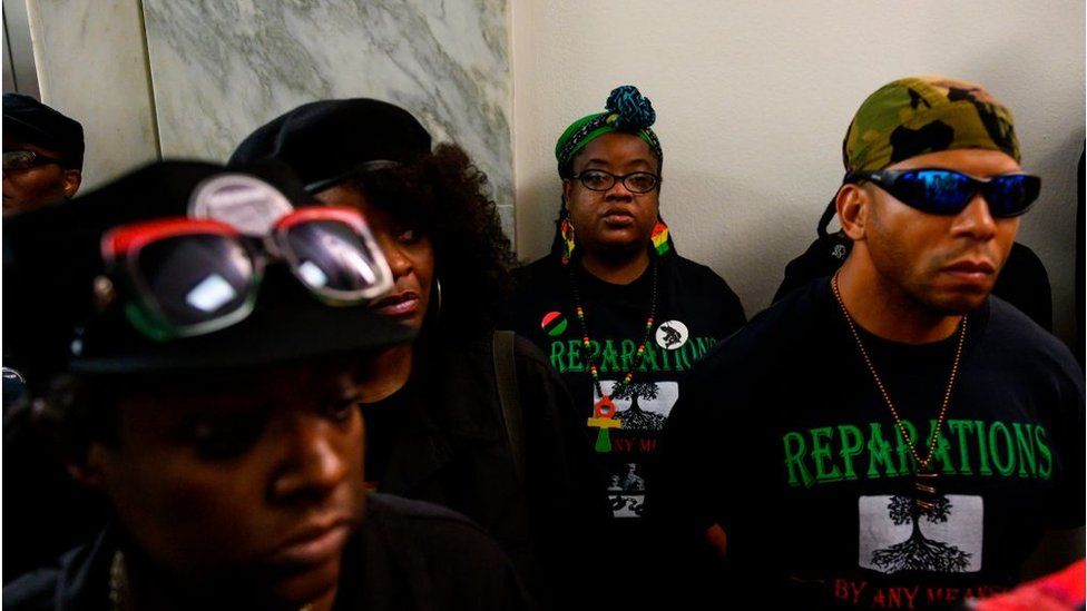 Activists stand in line waiting to enter a hearing