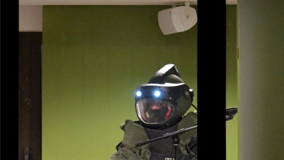 A member of a bomb disposal unit works inside a Jehovah's Witness meeting hall in Hamburg, Germany