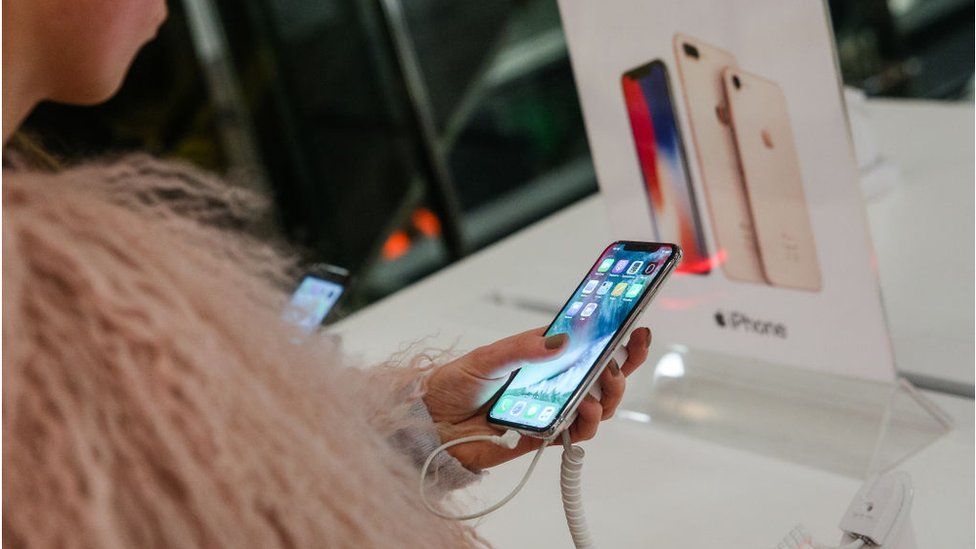 A woman tests an iPhone X