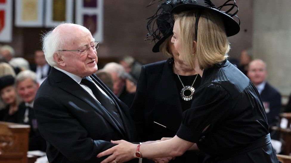 Irish President Michael D Higgins greeting Prime Minister Liz Truss at St Anne's Cathedral