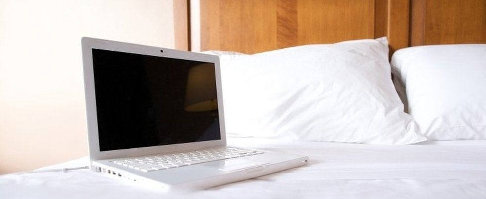 Laptop on a bed