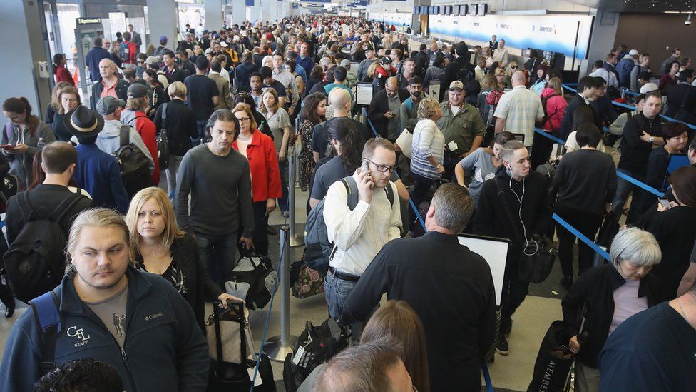 Passengers at O"Hare International Airport wait in line to be screened at a Transportation Security Administration (TSA) checkpoint on May 16, 2016 in Chicago, Illinois
