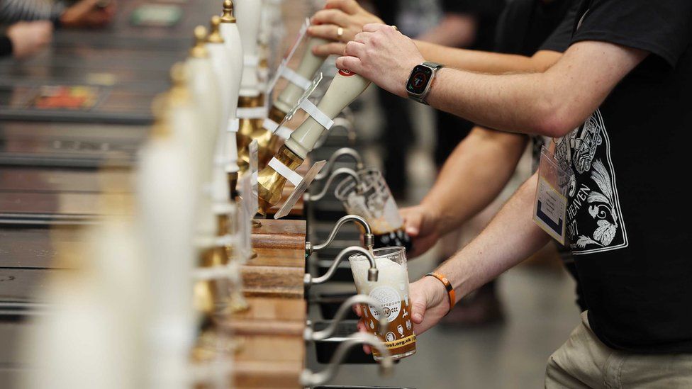 Beer is poured at a beer festival