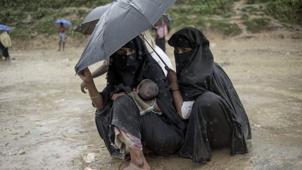 Rohingya Muslim refugees take shelter from the rain at Balukhali refugee camp in Bangladesh's Ukhia district (07 October 2017)_