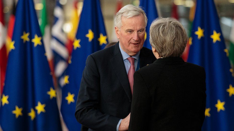 The EU's chief Brexit negotiator Michel Barnier greets British Prime Minster Theresa May at the Council of the European Union, 23 March 2018