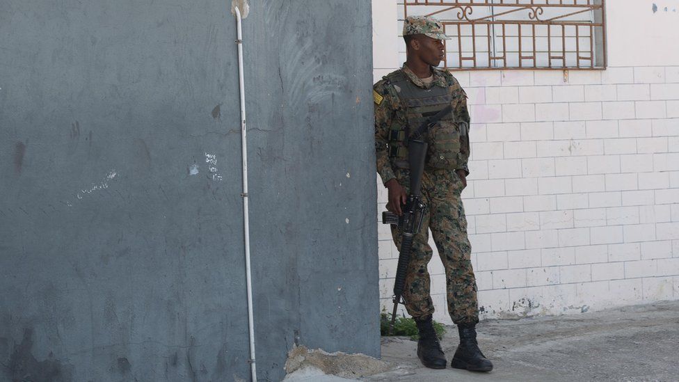A soldier on patrol in a side street that leads from Spanish Town Road into Denham Town