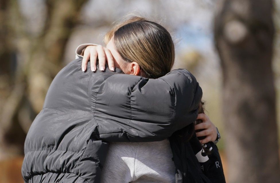 Beckton fire death: women hug