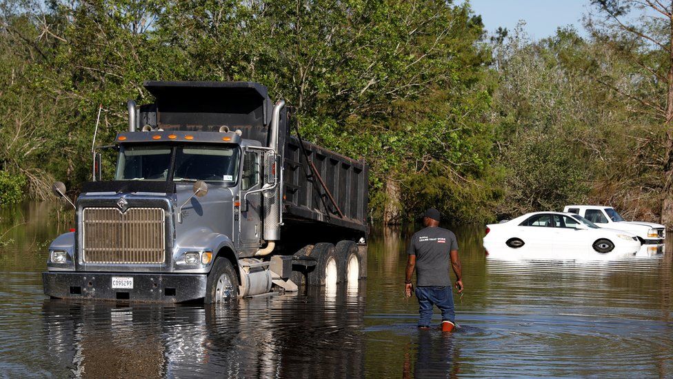 A truck is surrounded by flood waters after Hurricane Delta, in Lake Charles, Louisiana