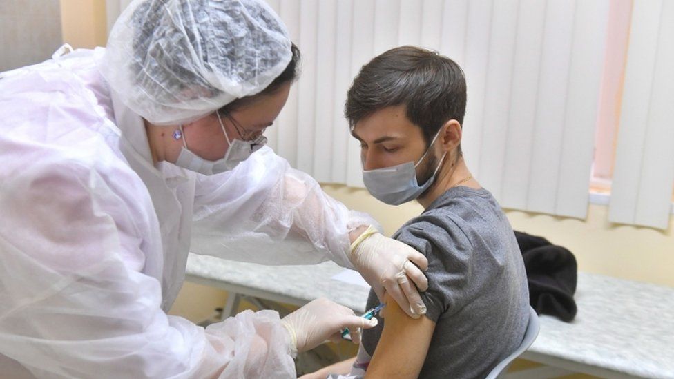 Man receives vaccine at Moscow polyclinic - 5 December - Moscow News Agency handout photo