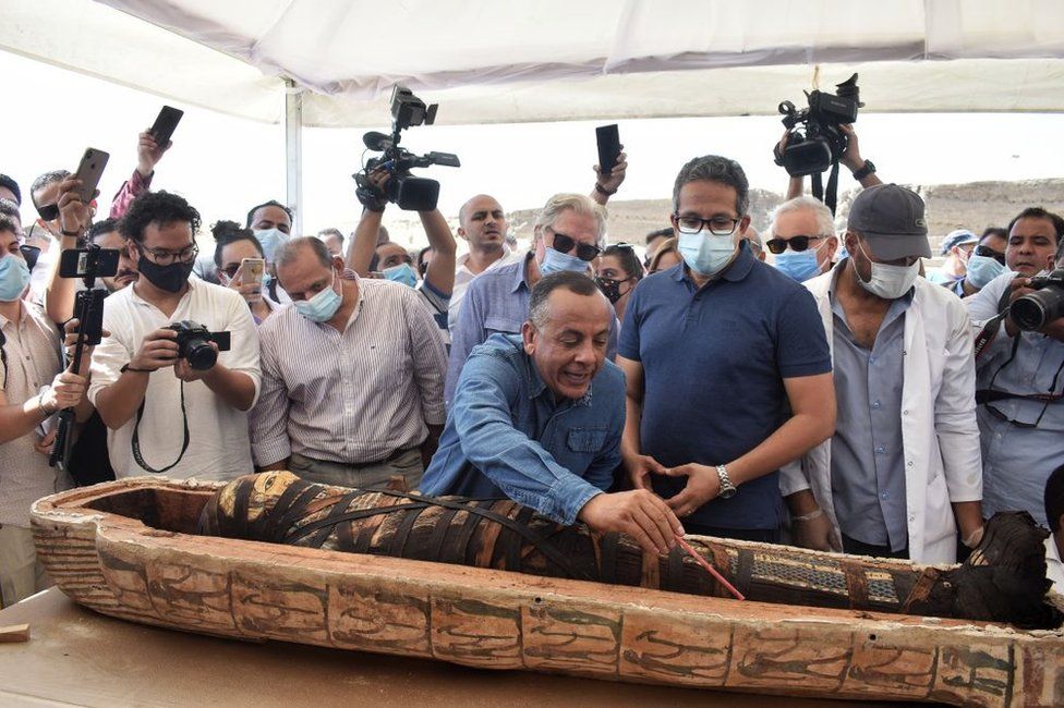 Officials unseal the sarcophagus in front of cameras.