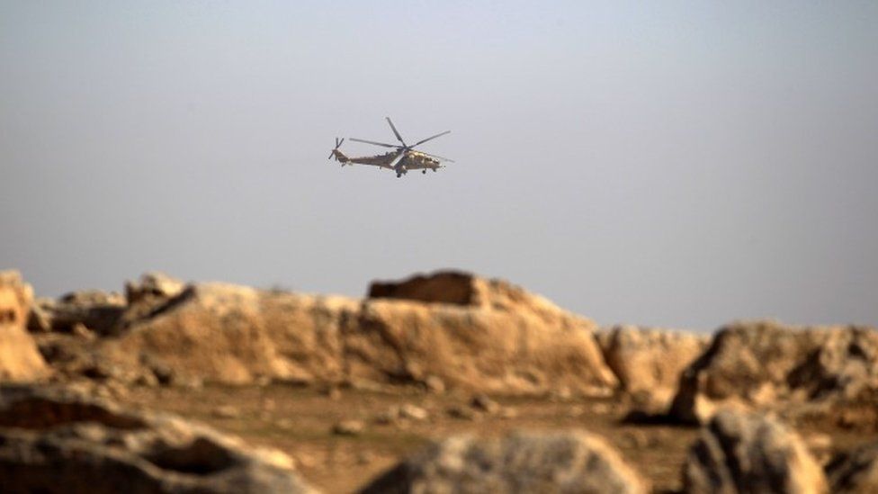 An army military helicopter flies over the Iraqi rapid response forces position during a battle against Islamic State militants in the south of Mosul, Iraq