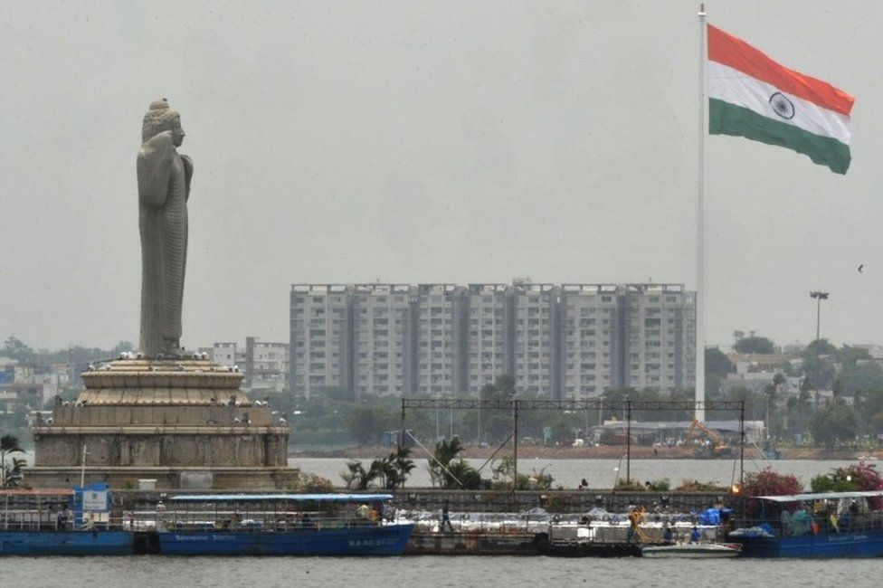 An Indian Tricolour flag flutters on an 83 metre (272.31 feet) flagpole after being unfurled during a ceremony to mark the Second Telangana State Formation Day at Sanjeevaiah Park on the banks of the Hussainsagar Lake in Hyderabad on June 2,
