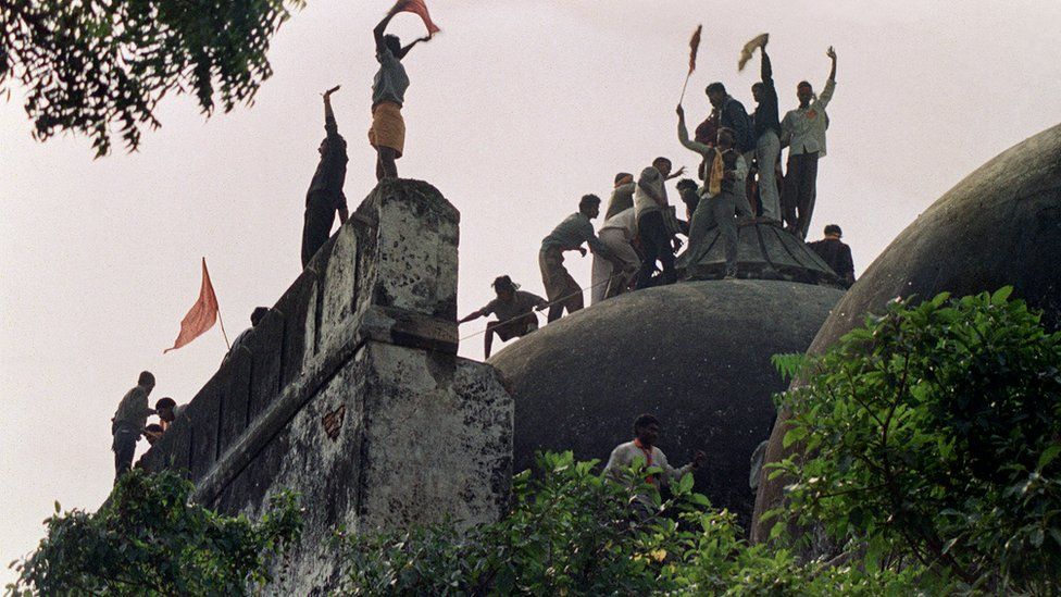 In this file photograph taken on December 6, 1992 Hindu youths clamour atop the 16th century Muslim Babri Mosque five hours before the structure was completely demolished by hundreds supporting Hindu fundamentalist activists.