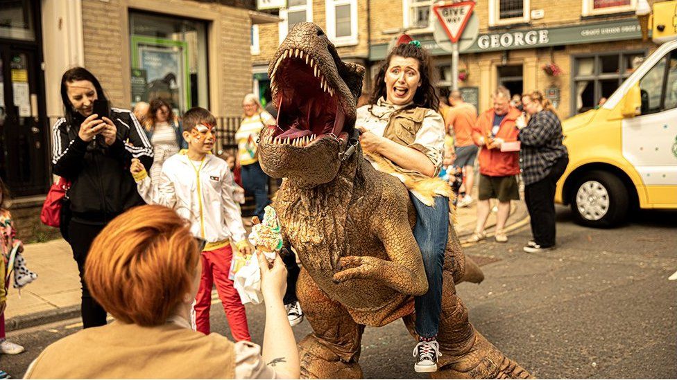 Woman riding on a dinosaur