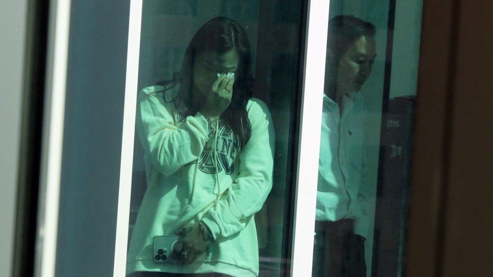 Peter Wang's mother Hui Wang wipes away a tear after the jury rejected a death sentence