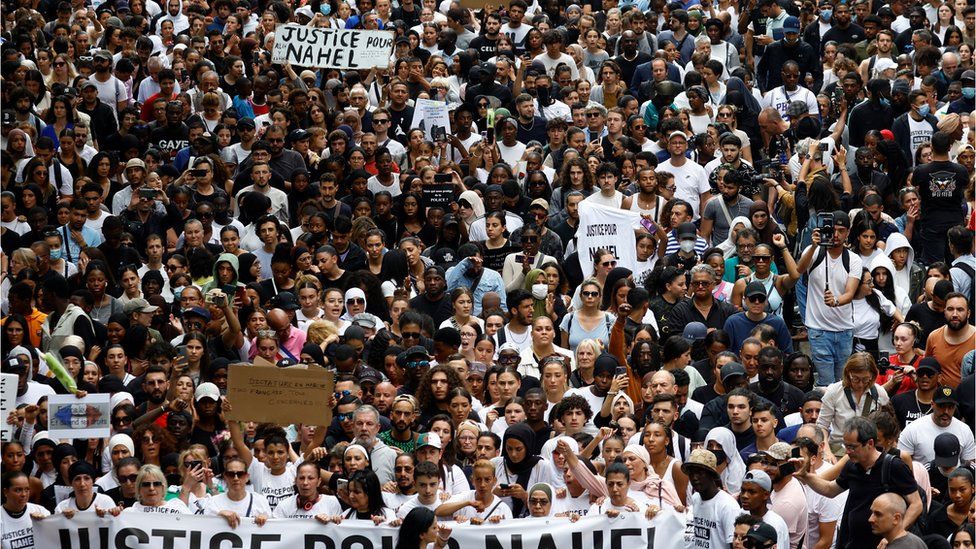 People attend a march in tribute to Nahel, a 17-year-old teenager killed by a French police officer during a traffic stop