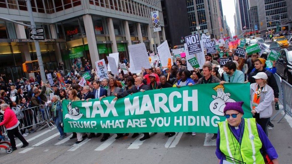 Protestors take part in the "Tax March" to call on US President Donald Trump to release his tax records on 15 April 2017 in New York.