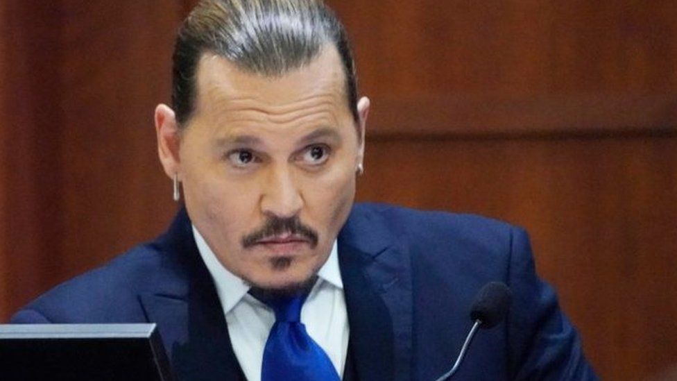 Actor Johnny Depp sits to testify in the courtroom at the Fairfax County Circuit Courthouse in Fairfax, Virginia, April 25, 2022