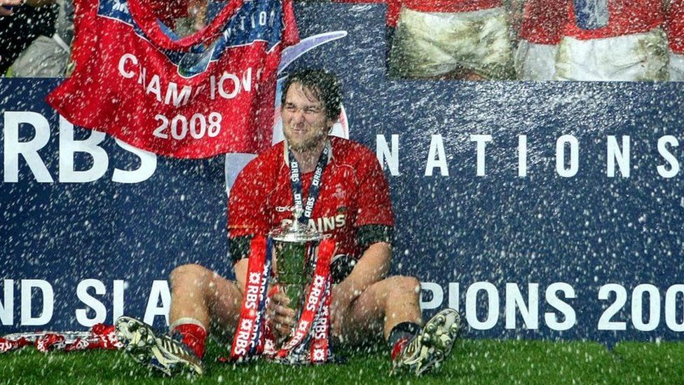 Wales"s captain Ryan Jones sits in a shower of Champagne with the 6 Nations trophy after the RBS 6 Nations match at the Millennium Stadium, March 2008