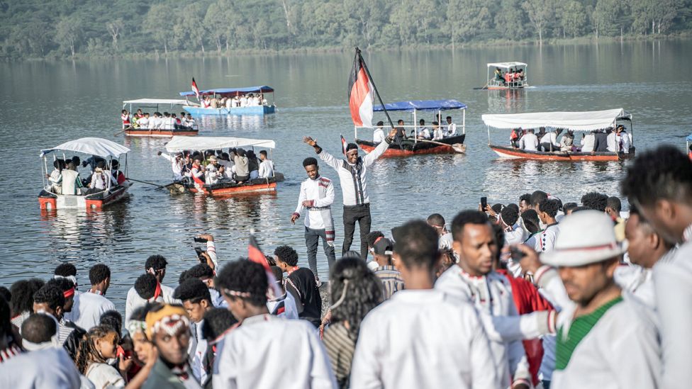 People and boats at Hora Arsad during the Ireecha festival in Bishoftu, Ethiopia - Sunday 8 October 2023