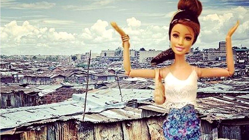 Barbie in front of a slum