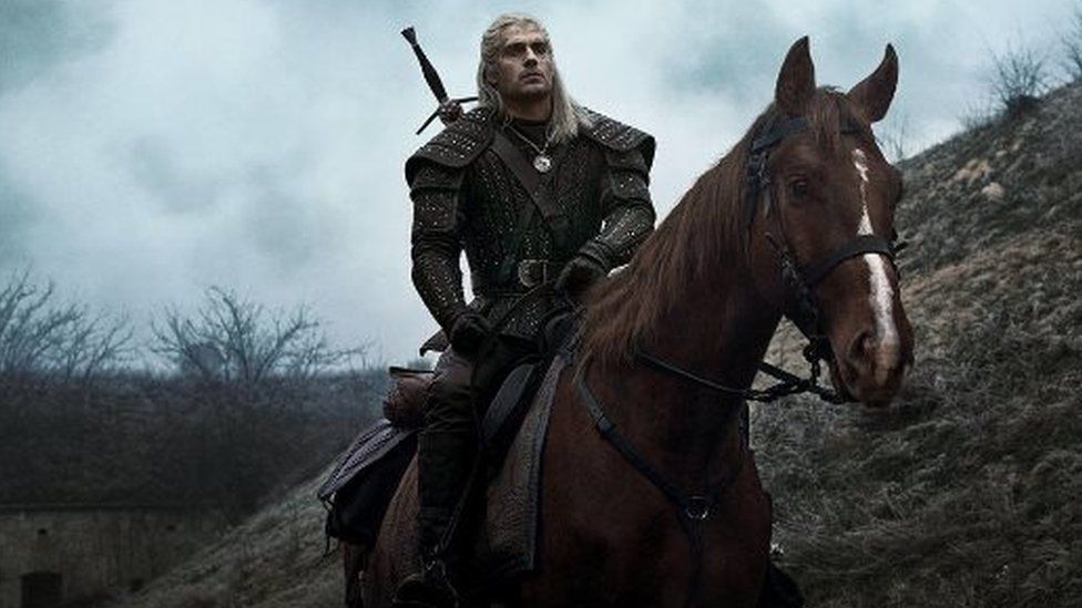 Henry Cavill as Geralt of Rivia with his horse Roach