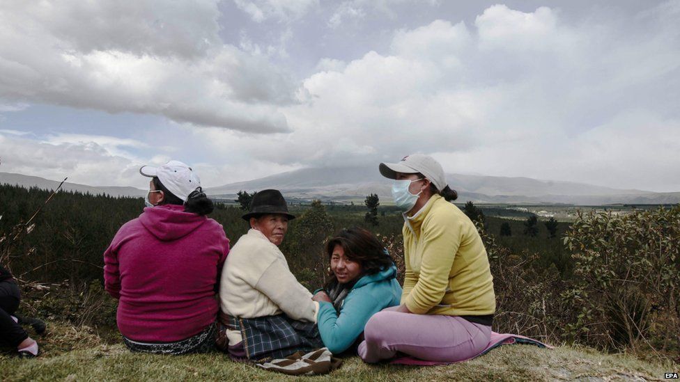 Evacuated inhabitants of Santa Rita town in Cotopaxi province look on at the rumbling volcano on Saturday