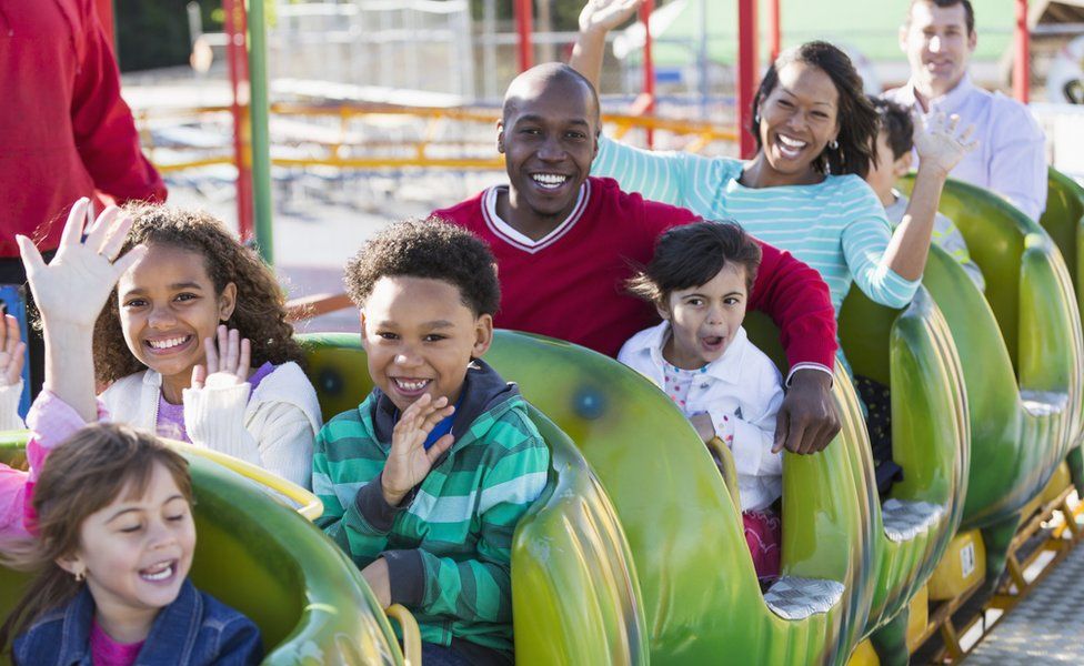 Parents and kids on mini rollercoaster