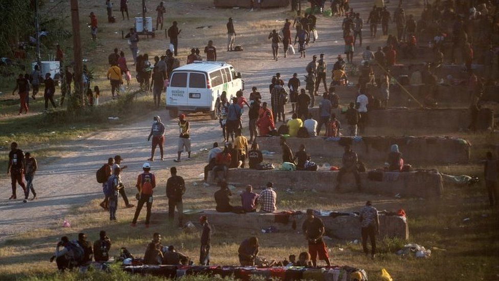 Migrants seeking asylum in the US rest near the International Bridge between Mexico and the US as they wait to be processed, in Del Rio, Texas, on 16 September 2021