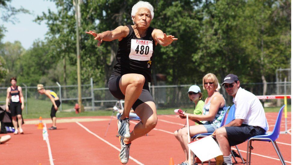 Carol LaFayette-Boyd is seen participating in a triple jump when she was 66.