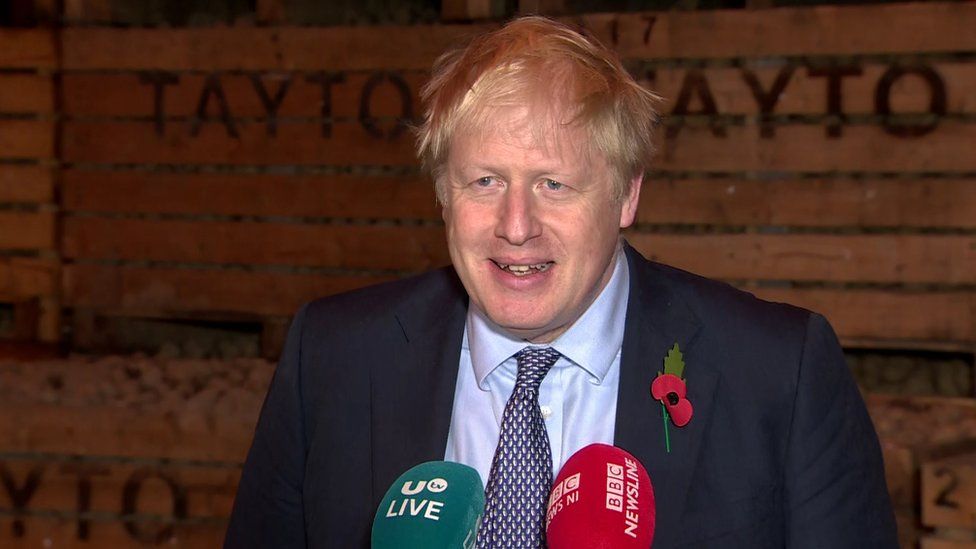Boris Johnson speaking at a press conference at the Tayto factory