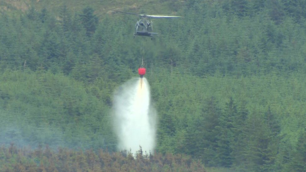 Helicopter dumping water