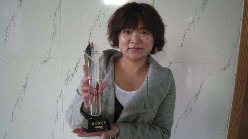 Women activist Wu Rongrong, 30, poses with a trophy in this undated handout picture taken in an unknown location in China, provided by a women's rights group on 8 April 2015