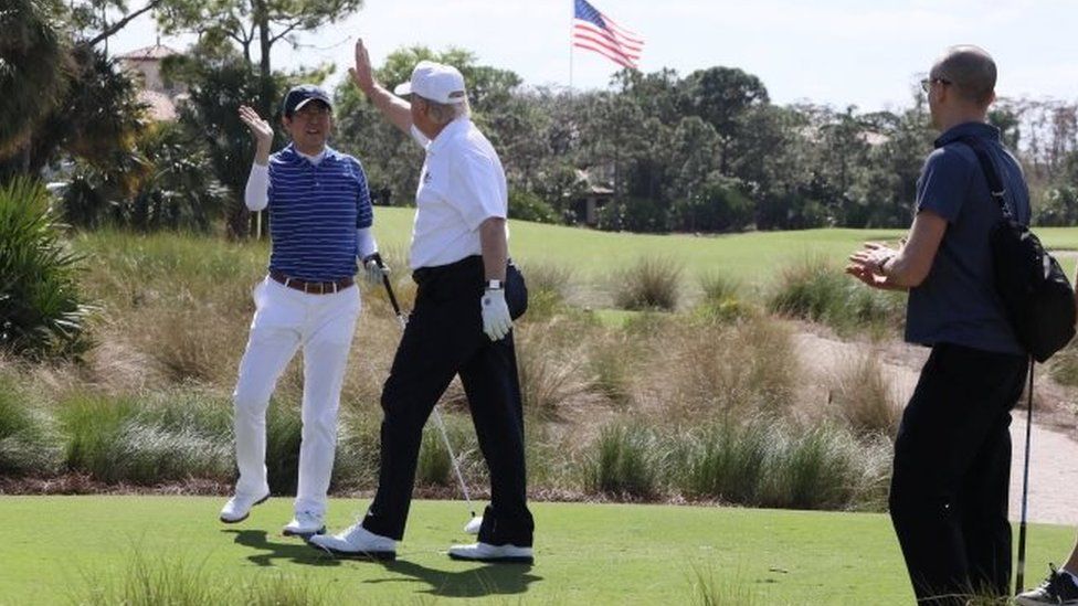 President Donald Trump (R) and Japanese Prime Minister Shinzo Abe (L) are seen at Trump International Golf club in West Palm Beach, Florida.
