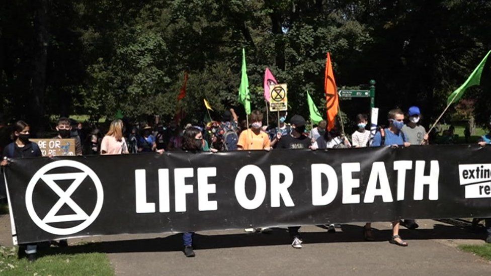 Protesters with a banner saying 'life or death'