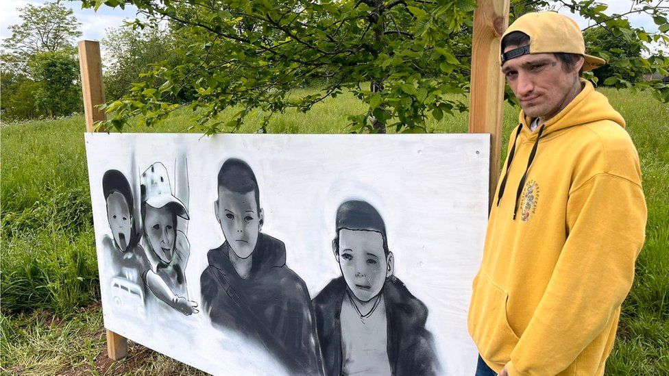 Graffiti artist Jay Grimes, standing by the mural which he worked on to the four boys who died in the lake in December 2022