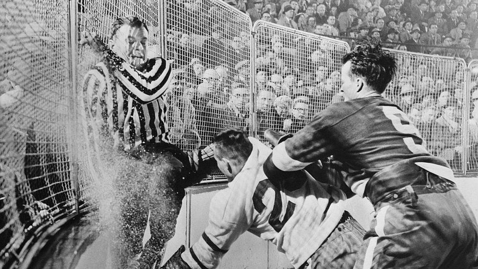 Old black and white photo of a hockey fight