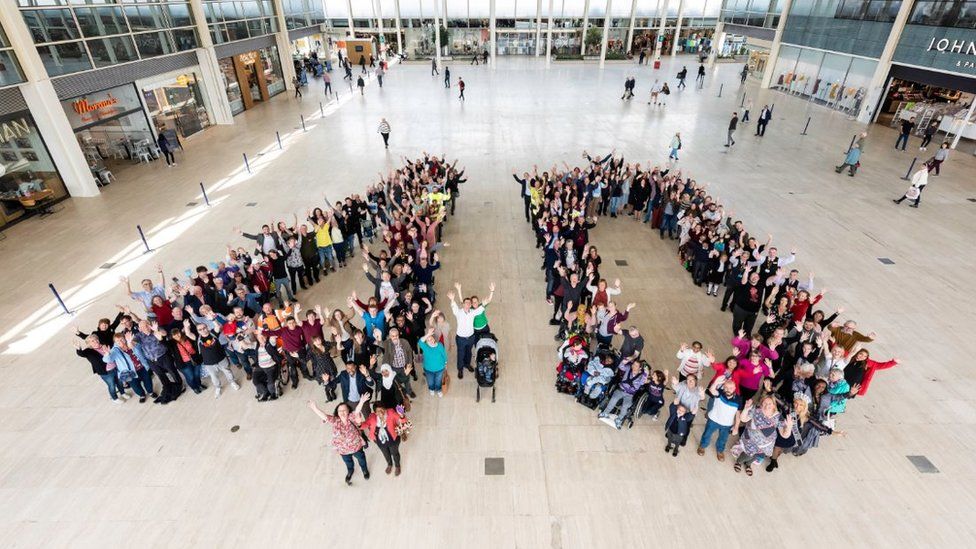 People standing in the shape of a large 40 in the Centre:mk shopping centre