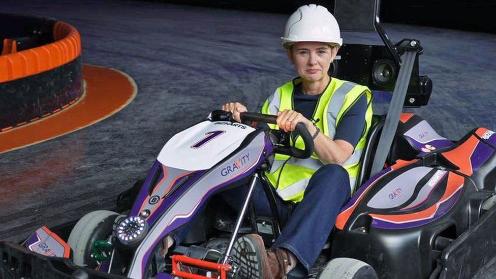 BBC Business Correspondent Emma Simpson tries out go-karting on a track in a former Debenhams beauty hall