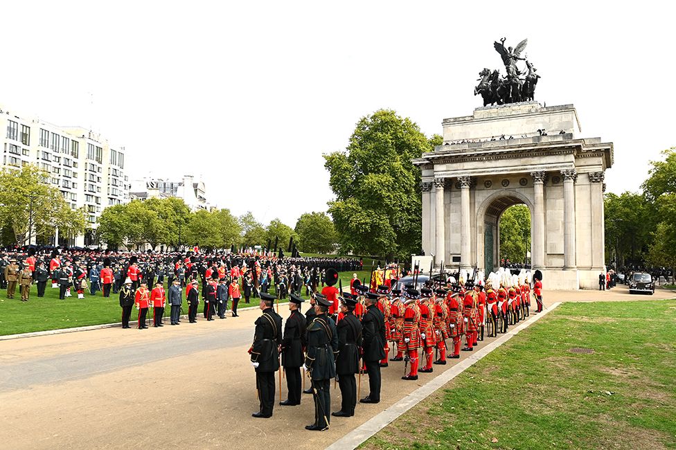 The coffin of Queen Elizabeth II with the Imperial State Crown resting on top, borne on the State Gun Carriage of the Royal Navy followed by members of the royal family proceeds past The Wellington Arch on September 19, 2022 in London