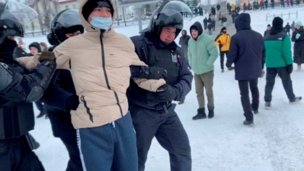Law enforcement officers detain a demonstrator protesting the court verdict against a leading rights activist in the city of Ufa in the Republic of Bashkortostan, Russia in this still image from video