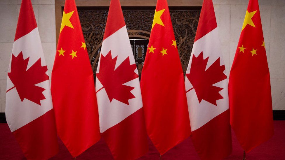 This picture taken in 2017, shows Canadian and Chinese flags taken prior to a meeting with Canada's Prime Minister Justin Trudeau and China's President Xi Jinping