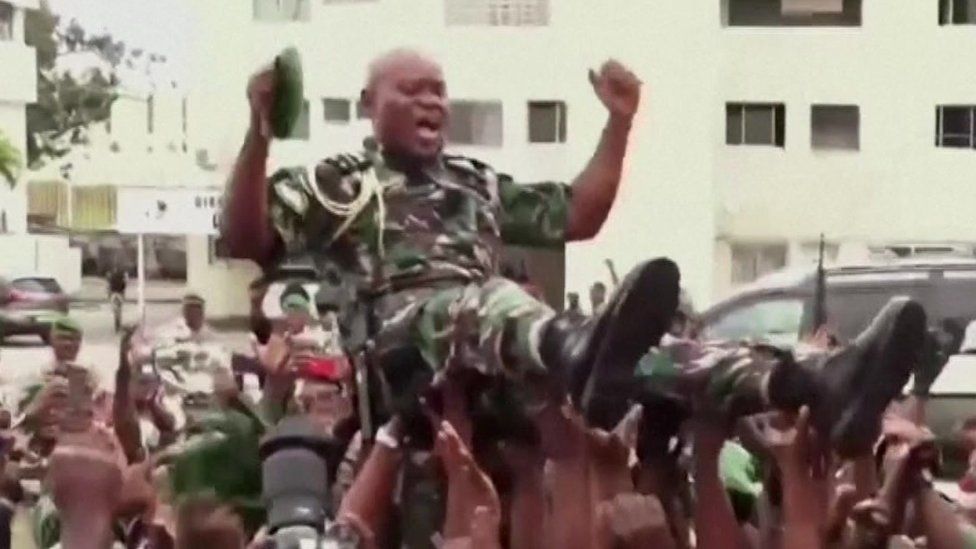 Gen Nguema is carried triumphally through the streets of the capital Libreville by his troops