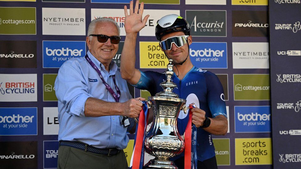 Spanish cyclist Gonzalo Serrano receives the trophy