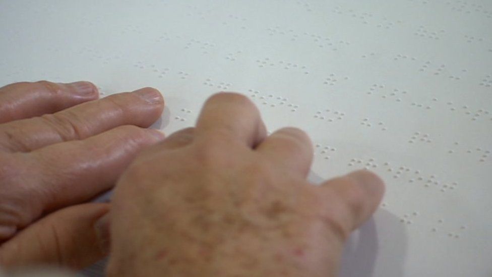 Person reading braille