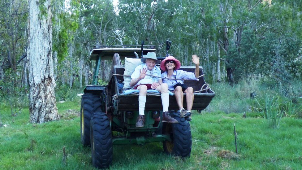 Dr David Goodall sits with relative on a tractor in Australia