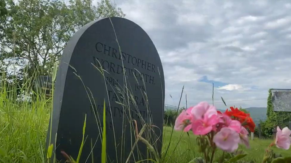 Christopher's gravestone with flowers in the foreground