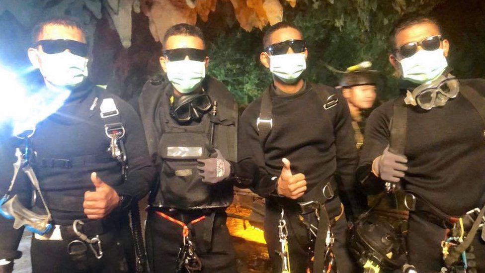 The last four Thai Navy SEALs giving a thumbs up after exiting safely from the Tham Luang cave in Khun Nam Nang Non Forest Park in Mae Sai district,